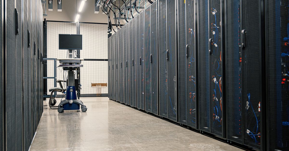 Steel cabinets of servers and bundled network cables in a data centre